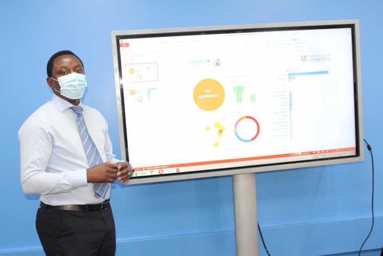 Prof. Thumbi Mwangi demonstrates how CEMA data system works.