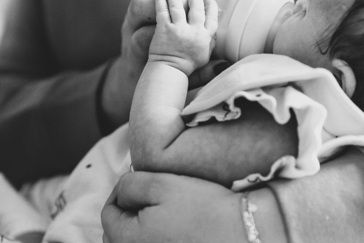 Picture of a mother bottle feeding a baby.