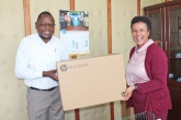     Prof. Julius Oyugi, Director Research, UNITID hands over computer donation to Prof. Evelyn Wagaiyu, Associate Dean Postgraduate.