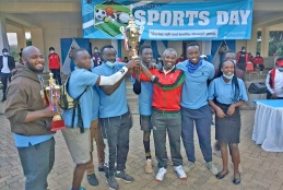 University of Nairobi Vice Chancellor, Prof. Stephen Kiama hands over the 1st runners up trophy to College of Health Sciences team during the 2021 annual sports day. 