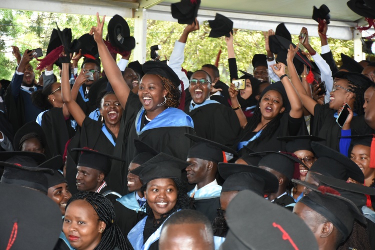 Graduands in jubilation during graduation.