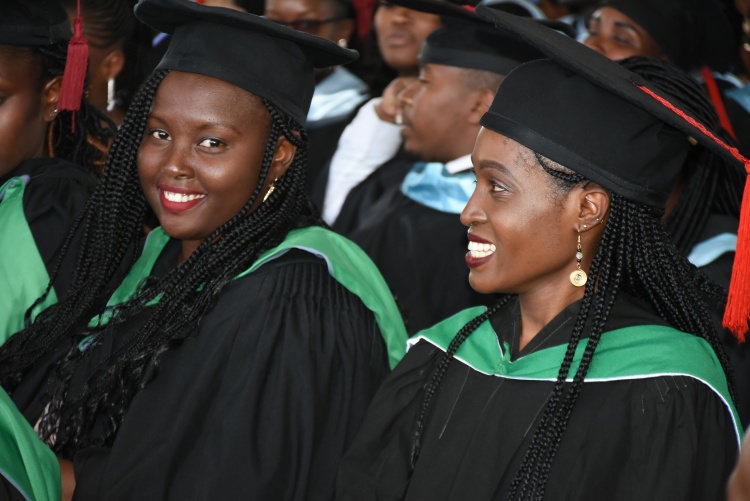 Graduands follow graduation proceeding.