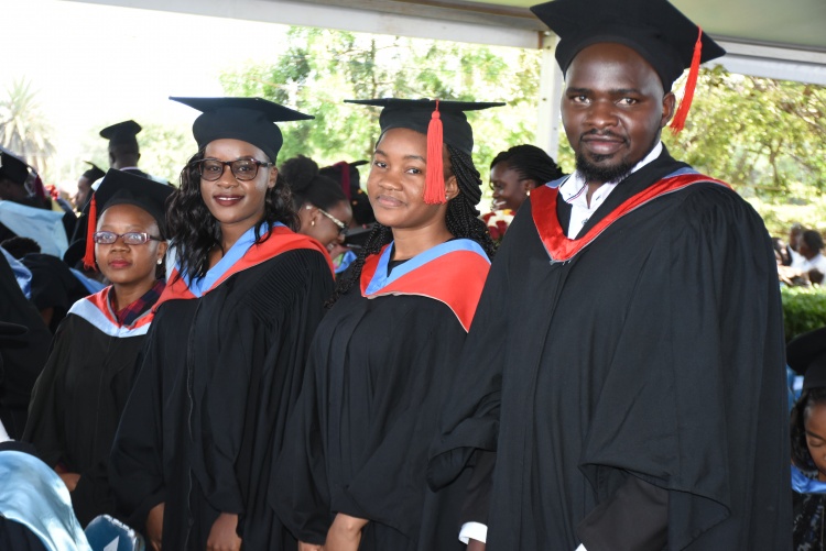 Graduands arise after their names are read during the 62nd graduation ceremony.