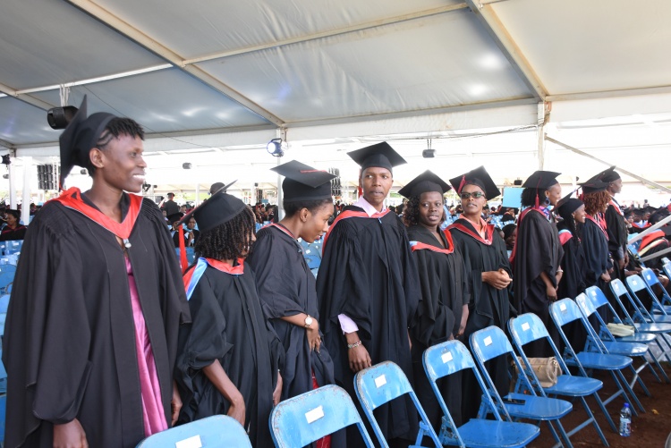 Graduands arise after hearing their names being read at the graduation ceremony.