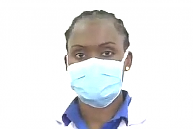 A doctor putting on a face-mask.