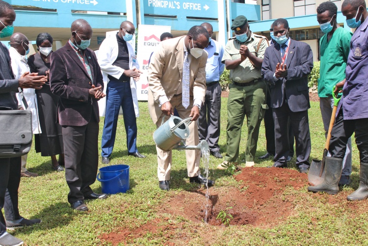 College of Health Sciences Principal, Prof. James Machoki waters a seedling he planted at the college during the tree planting drive.