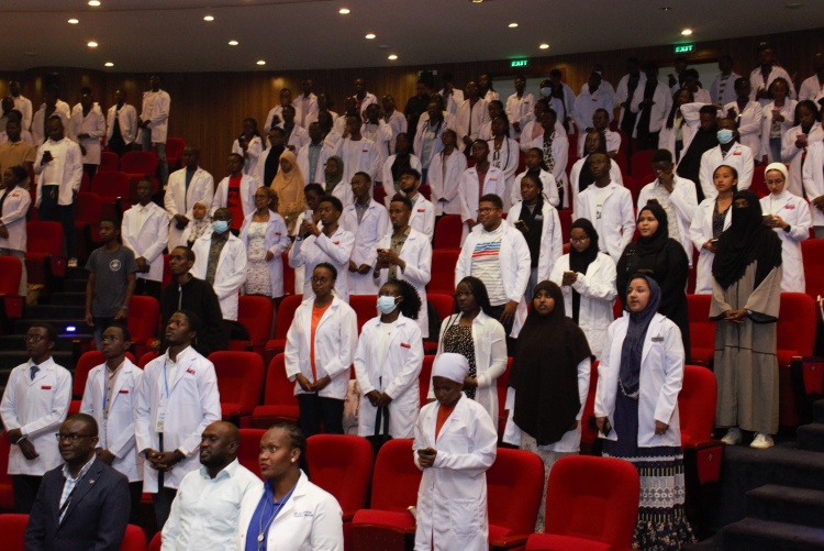 The cloaked students reciting the oath