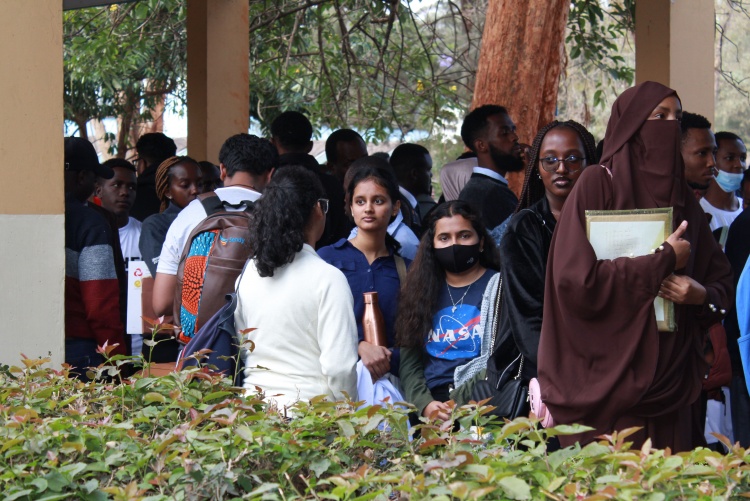 Students and parents waiting in line to be admitted.