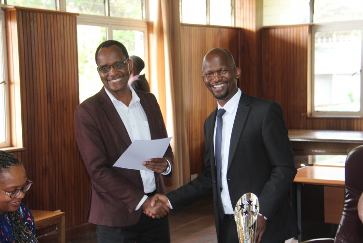 Faculty of Health Sciences Dean Prof. George Osanjo(R) with Dr. Mua Bernard from the Department of Dental Sciences during the signing of the 2022/2023 performance contract.