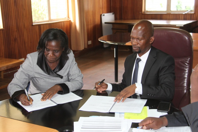 Faculty of Health Sciences Dean Prof. George Osanjo(R) with Dr. Callen Onyambu, Chair Department of  Diagnostic Imaging and Radiation Medicine during the signing of the 2022/2023 performance contract.