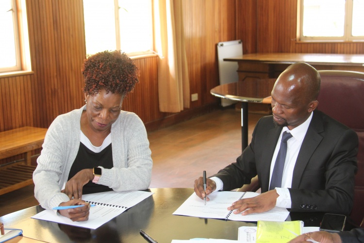 Faculty of Health Sciences Dean Prof. George Osanjo(R) Prof. Anne Obondo, Chair Department of Psychiatry  during the signing of the 2022/2023 performance contract.