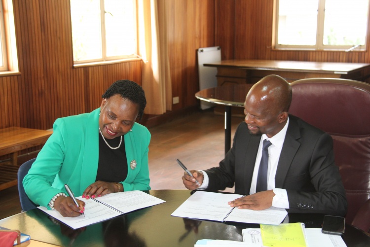 Faculty of Health Sciences Dean Prof. George Osanjo(R) with Dr. Grace Irimu, Chair of Paediatrics and Child Care during the  signing of the 2022/2023 performance contract.