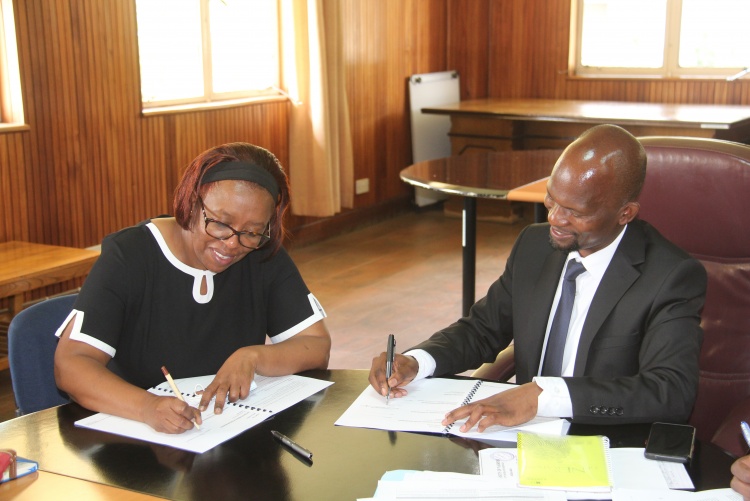 Faculty of Health Sciences Dean Prof. George Osanjo(R) with Dr. Waweru Wairimu , Chair Department of Human Pathology during the  signing of the 2022/2023 performance contract.