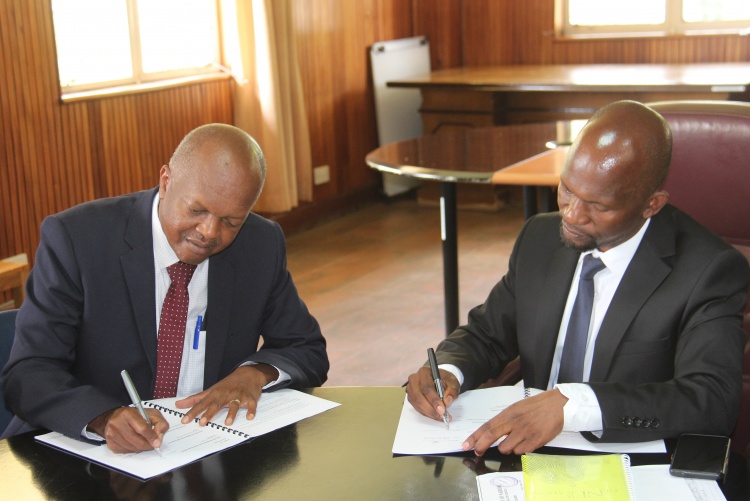 Faculty of Health Sciences Dean Prof. George Osanjo(R) with Dr. Stephen Gichuhi, Chair Department of Ophthalmology during signing of the 2022/2023 performance contract.