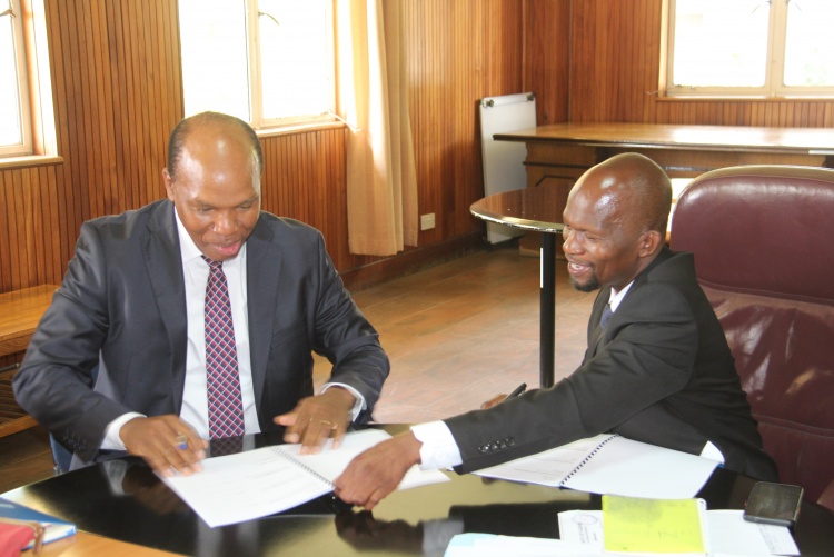 Faculty of Health Sciences Dean Prof. George Osanjo(R) with Dr. Julius Kiboi, Chair Department of Surgery during the signing of the 2022/2023 performance contract.