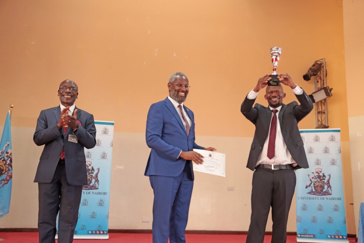 Faculty of Health Sciences Dean Prof. George Osanjo being awarded the trophy and certificate for the best performing faculty by the Vice Chancellor, Prof. Stephen Kiama, looking on is Prof. Julius Ogeng'o, Deputy Vice Chancellor, Academic Affairs.