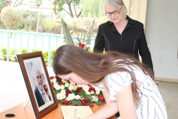Signing of Prof. Frank Plummer's condolence book during a funeral service at the College of Health Sciences.