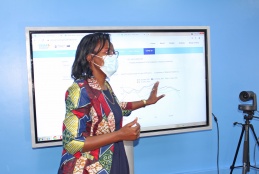 Dr. Loice Achieng' Ombajo demonstrates how CEMA database works during the official launch.