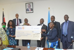 University of Nairobi Vice Chancellor Prof. Stephen Kiama receives a dummy cheque from Rotary Club officials. 
