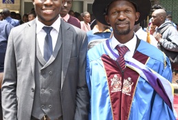 Collins Miheso, the best student in academic perfomance at the Faculty of Health Sciences poses for a photo with the Dean Prof. George Osanjo.
