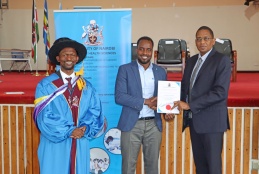 Dr. Thomas Chokwe presents the leadership award to Mohamed Jamal during the student recognition ceremony at Taifa Hall.Looking on is Prof. George Osanjo, Dean, Faculty of Health Sciences.