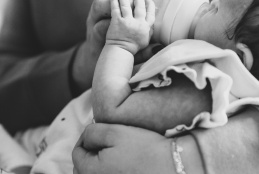 Picture of a mother bottle feeding a baby.